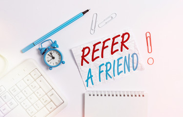 Poster - Handwriting text writing Refer A Friend. Conceptual photo direct someone to another or send him something like gift Copy space on the empty note paper with pc keyboard clock and pencil