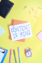Poster - Writing note showing Content Is King. Business concept for believe that content is central to the success of a website Flat lay above empty paper with pencils and paper clips