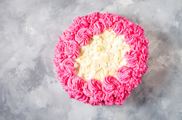 Cake with pink cream on concrete background. Top view