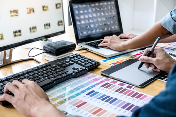 Poster - Young creative team having a meeting in creative office, Architectural drawing with work tools and accessories, Color swatch samples chart for selection coloring