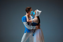 Modern Cinderella Not Trying The Slipper On, But Kissing With Protective Face Mask. Young And Graceful Ballet Dancers During Show On Studio Background. Art, Motion, Flexibility, Inspiration Concept.