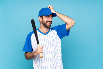 Wall Mural - Young man playing baseball over isolated blue background has realized something and intending the solution