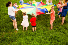 Close View Children Holding Large Colorful Parachute