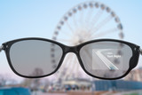 Fototapeta Nowy Jork - Smart glasses with maps and ferris wheel in the background