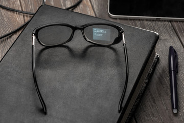 Smart glasses with classic style laying on a book