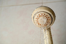 Stain On Shower Head Background.The Water Flows Slowly
