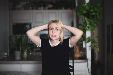 A woman pulls her hair in frustration