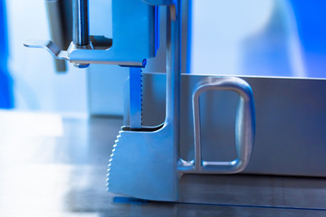 Poster - Band saw. Equipment for metal cutting. A fragment of a metal cutting machine. Industrial equipment. Heavy industry. Sale of equipment for metal processing. Band saw machine close-up.
