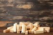 Wooden blocks disrupted on brown background. Top view