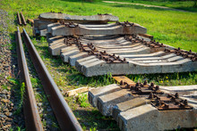 Dismantled Old Rails And Sleepers Lie On The Green Grass