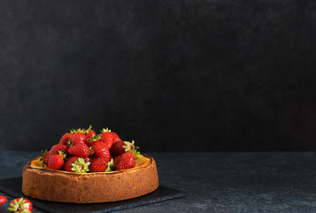 Canvas Print - Beautiful cheesecake with strawberries on a dark background with a place for texts. Food advertisement.