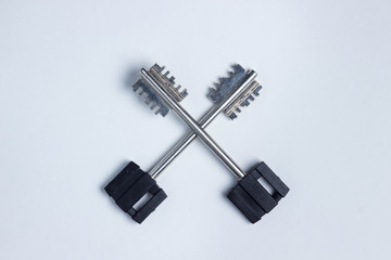 Two metal keys lie on a white background. Lie in the shape of a cross. Photo above