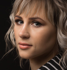 Close-up face of a girl with blond hair and smooth skin