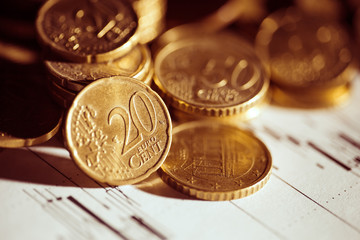 Euro coin on stock chart. Selective focus. Macro image.