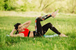© yanalev - Young woman practising yoga in the open air in the nature on the grass on the sunny day. Outdoor sports. Exercises for tonus, flexibility and power