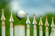 © Tatiana - the tops of a gray metal fence in the shape of an arrowhead and a ball