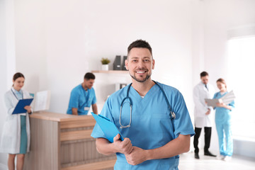 Poster - Portrait of male doctor in modern clinic