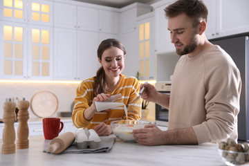 Sticker - Lovely young couple cooking dough together in kitchen