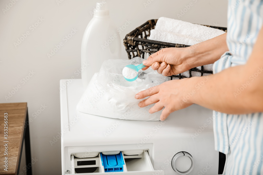 Woman doing laundry at home, closeup