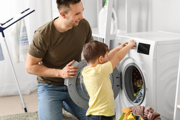 Sticker - Man and his little son doing laundry at home