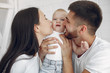 © prostooleh - Cute family in a room. Lady in a white shirt. Little boy with parents