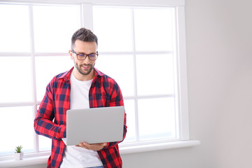 Poster - Young man with laptop working at home