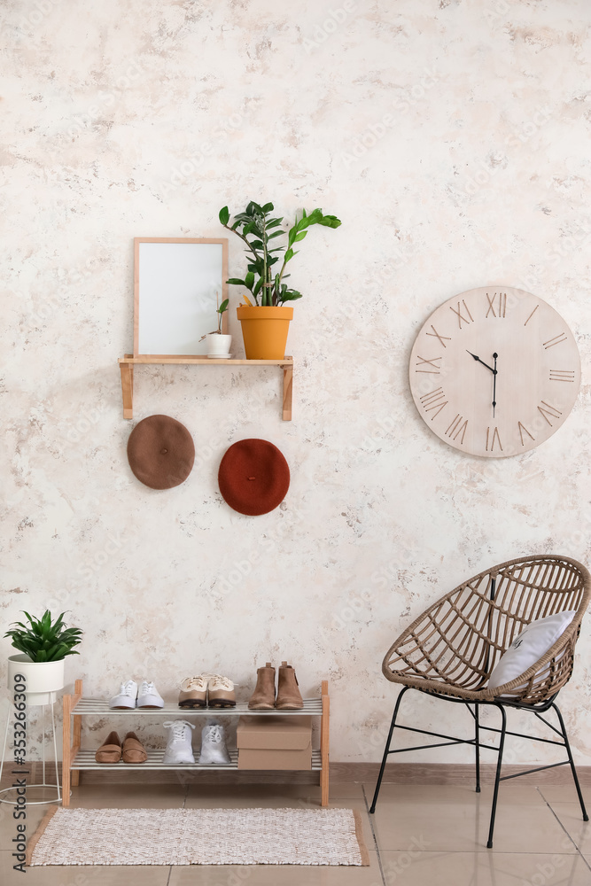 Stylish interior of modern hall with shoes on stand
