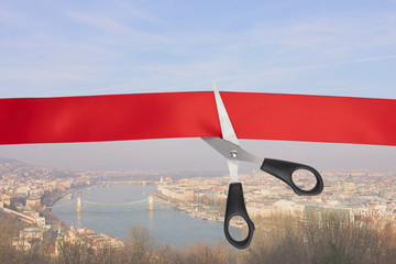 Wall Mural - Sale of tour packages. The end of the quarantine of the coronavirus pandemic. Scissors cut a red ribbon overlooking the Danube River in Budapest, Hungary