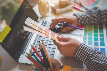 Fototapete - The graphic designer creative team is currently working on the design and color selection on the guide color for advertising design.