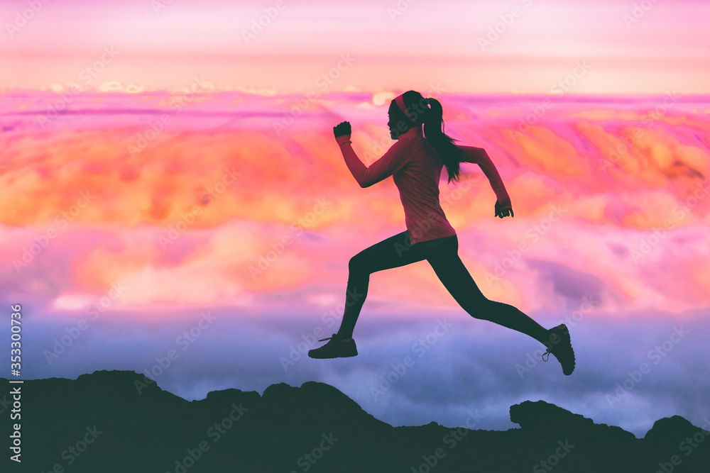 Trail running woman athlete runner exercising in mountains landscape background at sunset with pink color sky clouds. - obrazy, fototapety, plakaty 