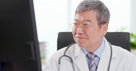 Sticker - Senior male doctor look computer