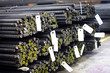 © Mdv Edwards - A bundle of new steel rebars on the floor, stockpiled in a warehouse.