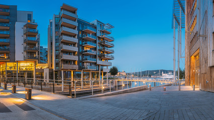 Wall Mural - Oslo, Norway. Night View Of Residential Multi-storey Houses In Aker Brygge District. Summer Evening. Residential Area. Famous And Popular Place