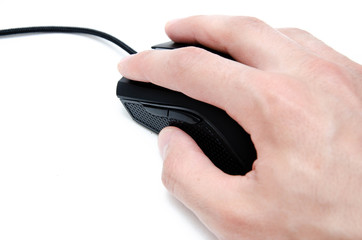 A male hand holds, controls, presses a wired black gaming mouse on a white background. The mouse is wired and wireless with additional side keys. Matte finish. Hand and mouse in macro and general plan