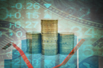 Stacks of coins with a business chart. Double exposure. Digital editing. Concept of savings, taxes or economy. The economic crisis. Rising or falling income.