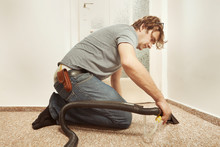 Caucasian Man Cleaning Deeply Carpet With Wet And Dry Vacuum Hand Adapter