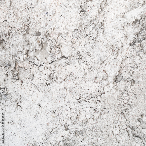 Textured uneven grey plastered or cement wall for background with lots of str...
