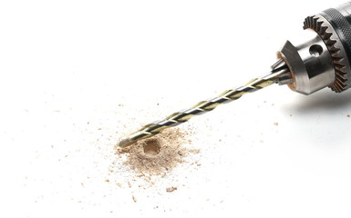 Electric power drill bit and hole with wood shavings isolated on white background