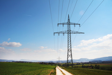 Electricity cable lines against bright blue sky