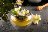 Jasmine tea. Jasmine flowers are brewed in a metal sieve. Double bottom cup. Flower tea.
