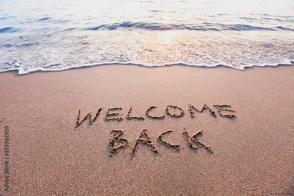 welcome back, text on sand beach, tourism after pandemic concept - obrazy, fototapety, plakaty 