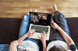 © Song_about_summer - group video call with family and friends, couple sitting on the couch using laptop computer