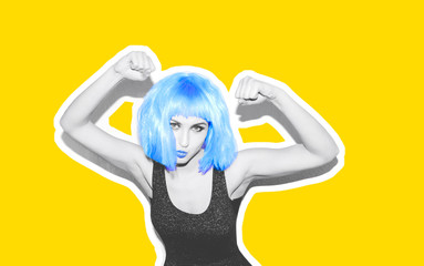 Beautiful sexy hipster girl in a bright blue wig. The face of an angry girl shows tongue and finger gestures. Black and white image. Collage yellow background.