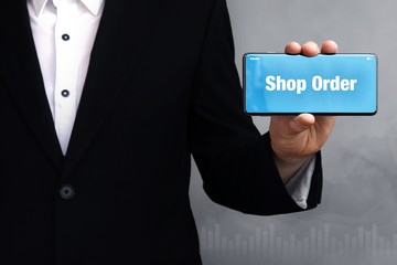 Shop Order. Businessman holding a phone in his hand. Man present screen with word. Blue Background. Business, Finance, Statistics, Analysis, Economy