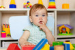 © Юлия Призова - Happy child girl plays toys at home, in kindergarten or in the nursery.