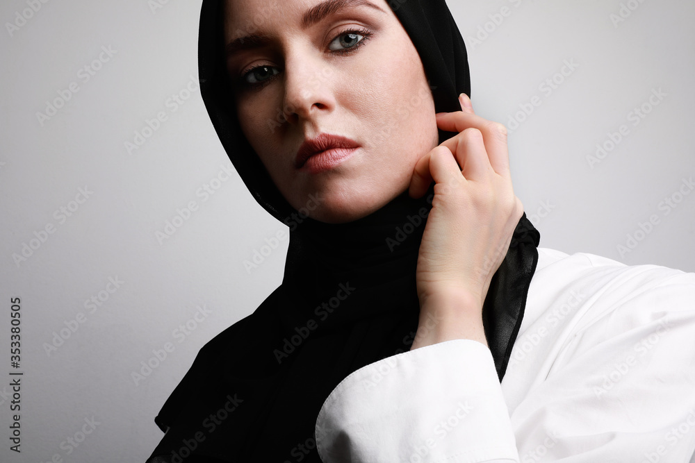 Side close-up portrait of beautiful muslim woman in hijab wearing white ...