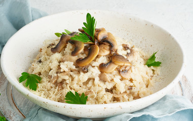 Wall Mural - Risotto with mushrooms in plate. Rice porridge with mushrooms and parsley