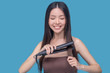 © zinkevych - Young asian woman straightening hair and feeling good