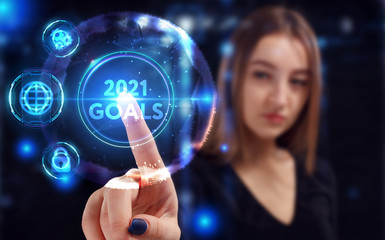 Business, Technology, Internet and network concept. Young businessman working on a virtual screen of the future and sees the inscription: 2021 goals