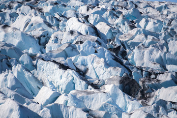 Icebergs floating. Ices and volcanic ash. Glacier lagoon. Melting ice. South coast Iceland.Volcanic ash on the arctic ice. Ice age glacier crevasse melting fast. Global warming. The edge of a glacier